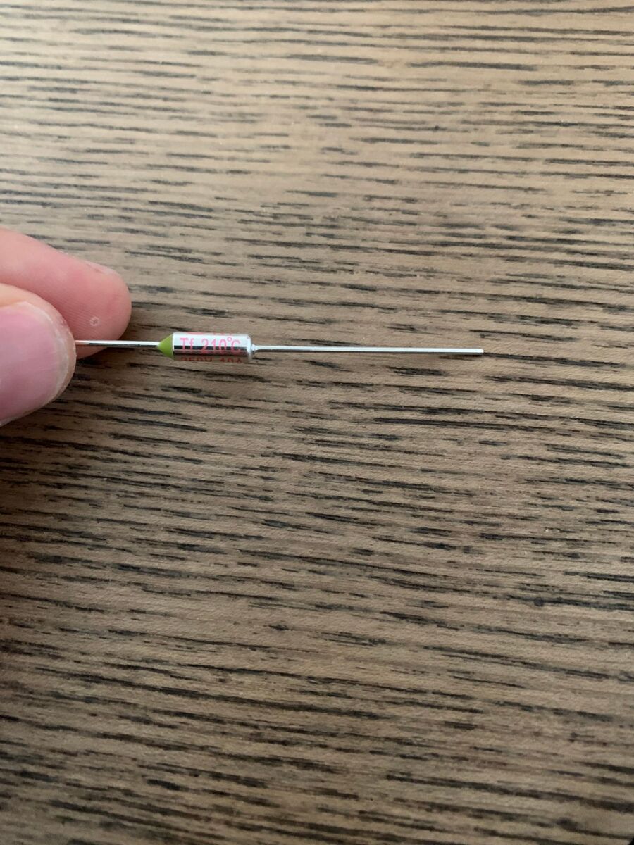The new thermal fuse, marked Tf 210 °C, 250 V 10 A.